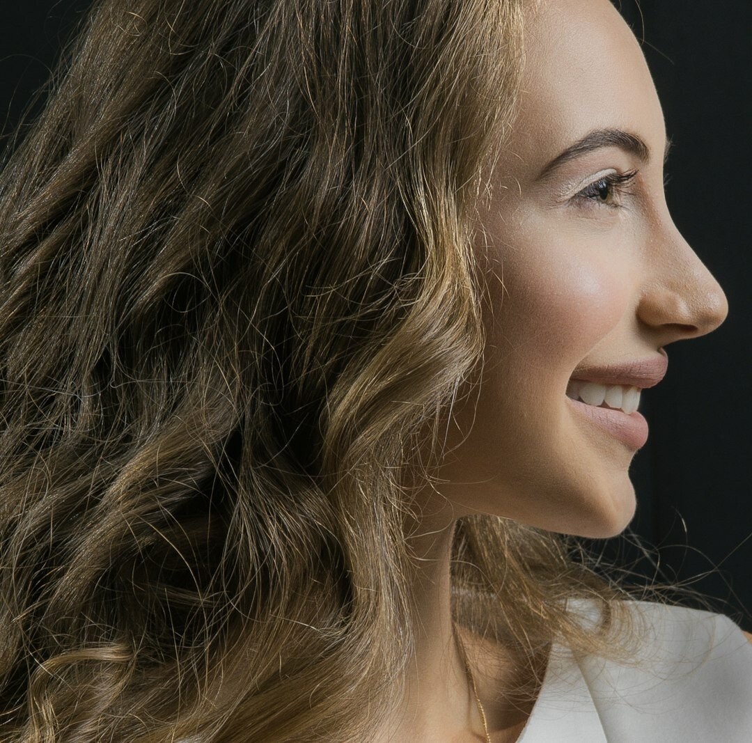 Studio portrait of a brazilian woman with curly hair smiling