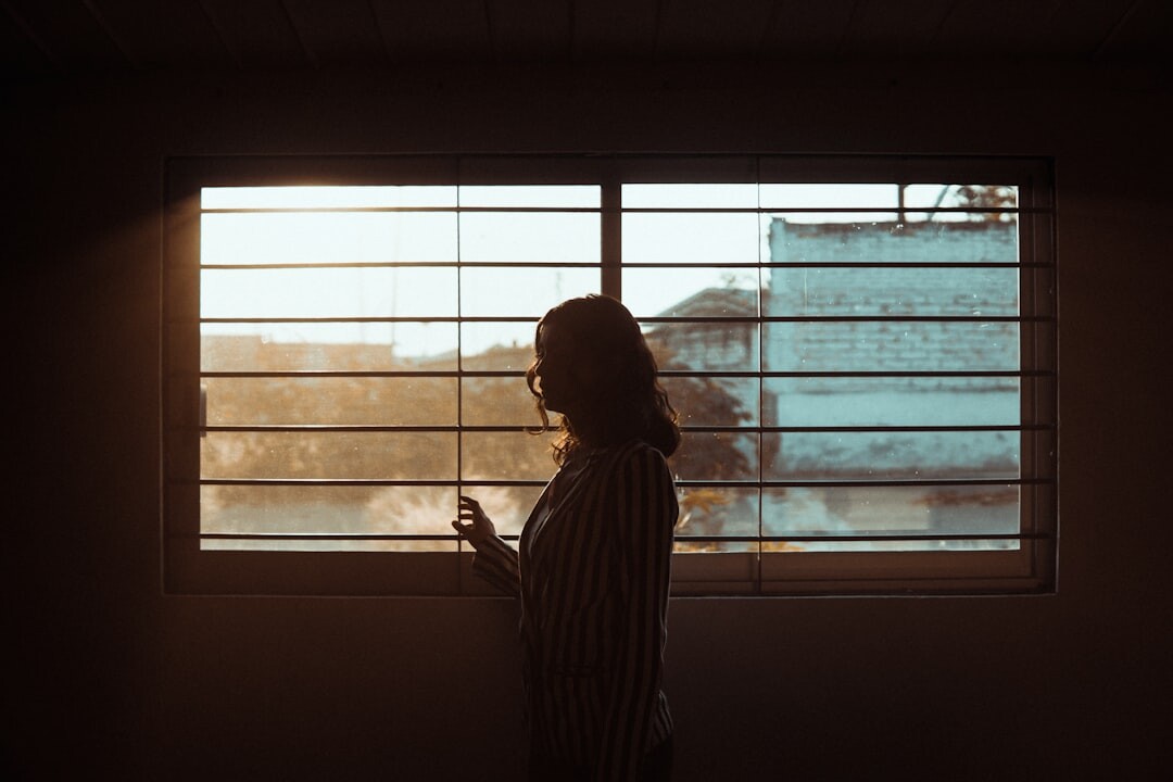 person reflecting by window