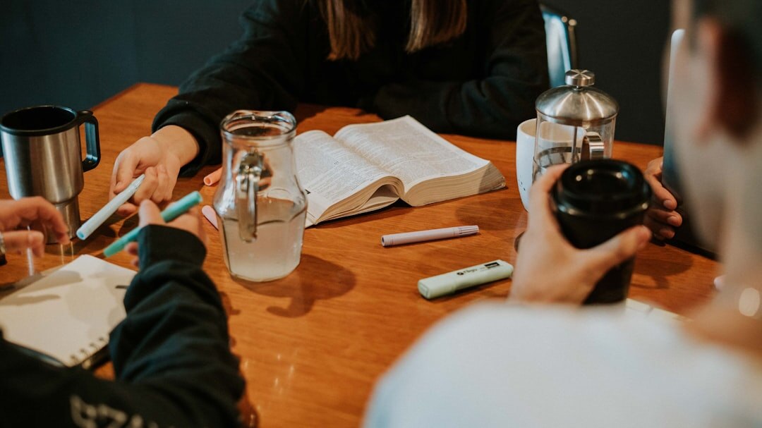 Small team of writers reviewing notes together at a table