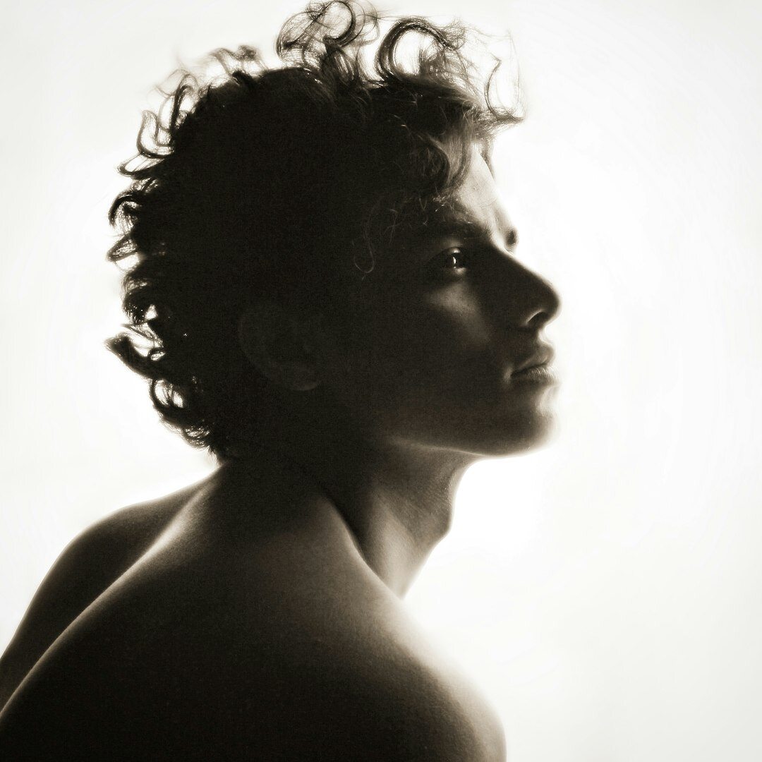 Studio portrait of a young brazilian man with curly hair