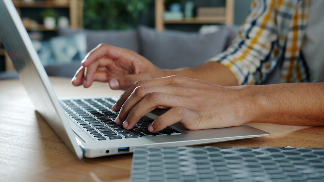 Person typing a message on a laptop at home