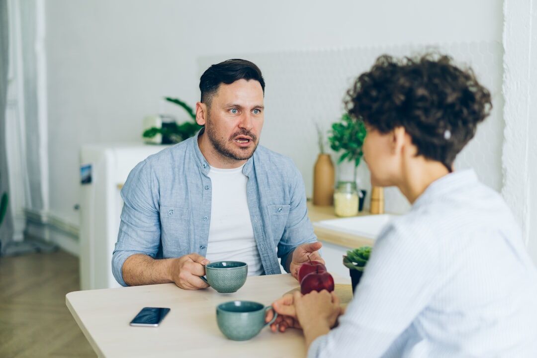 Two people in a calm, respectful conversation indoors